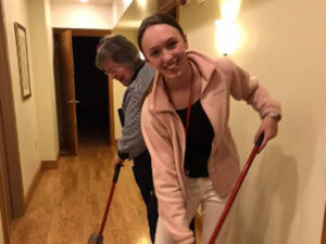 Volunteer sweeping the floor.